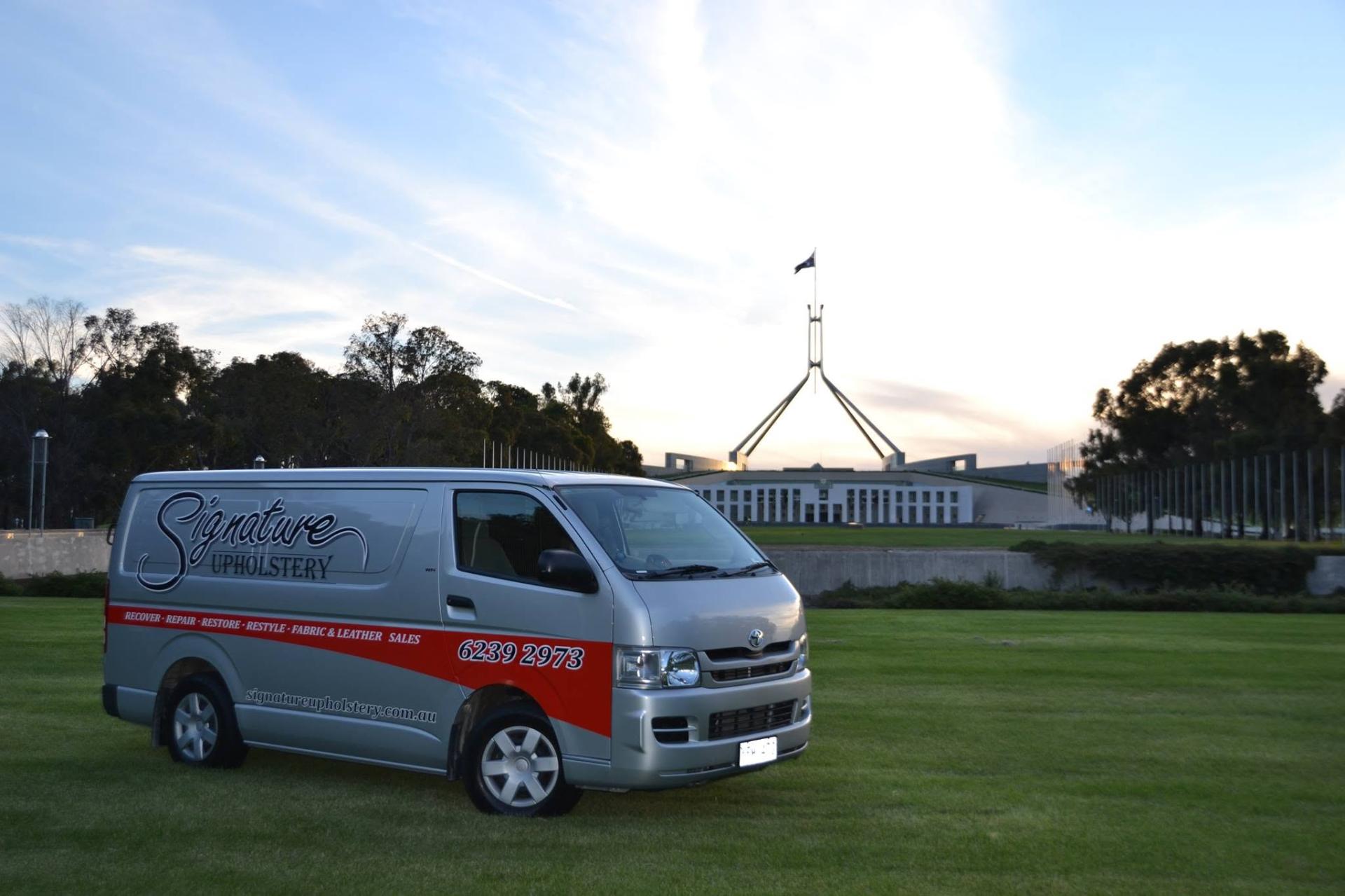 Signature Upholstery branded van parked in front of Parliament House, Canberra